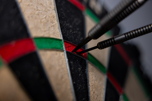 Darts in bull's eye close up. Darts arrows in the target center business goal concept. Slow Motion 4K.