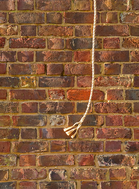 Rope hanging from a wall stock photo