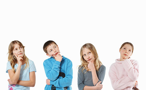 Innocent little kids thinking looking upwards with copyspace stock photo