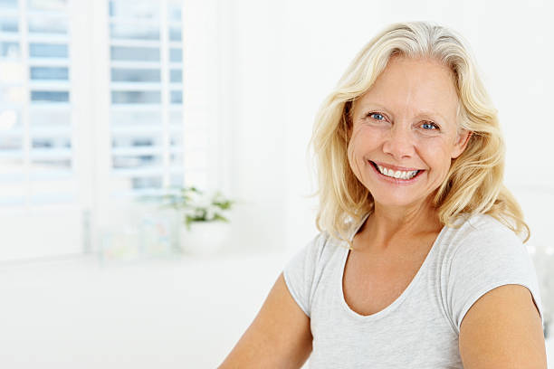 istock Beautiful elderly woman smiling while at home 182502911