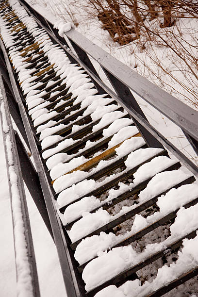 istock Endless wooden staircase with snow 182503090