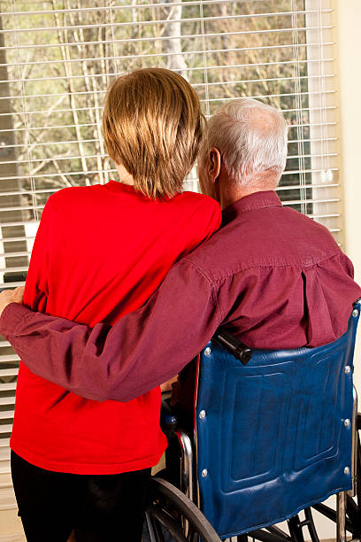 istock Senior man in wheelchair getting hug from grandson 182503461