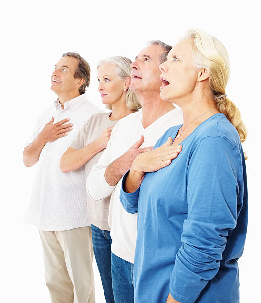 istock Senior people singing the National Anthem against white 182503551