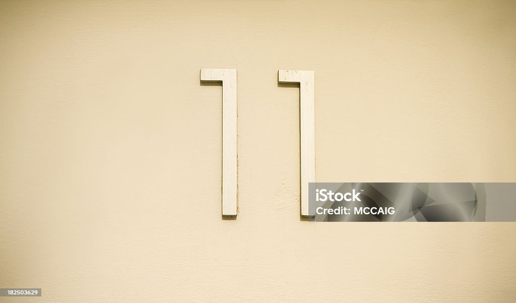 number 11 The number 11 on a sightly textured wall. Horizontal Stock Photo