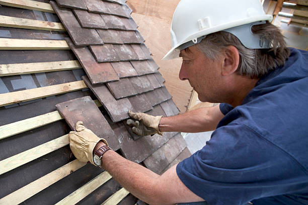 istock Construction Site Roofer Laying Roof Tiles 182504017