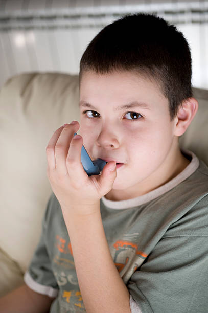 Asthma inhaler Asthma inhaler being used by boy corticosteroid stock pictures, royalty-free photos & images