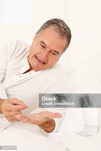 Elderly Man Taking Medication Before Sleep Stock Photo - Download Image Now - 60-69 Years, 65-69 Years, Adult
