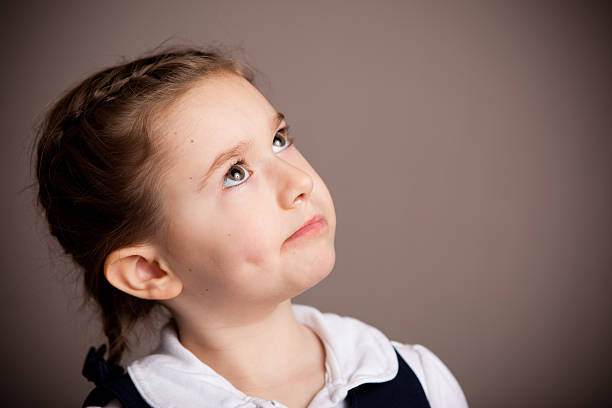 istock Smart Young Girl Student Thinking in School Uniform 182504707