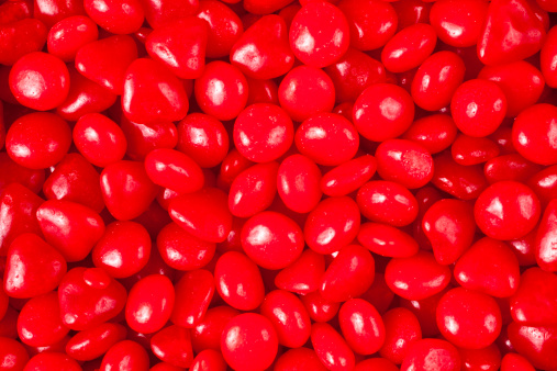Full frame of redhots candies for background.  Macro.