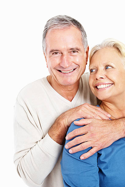 istock Happy senior man hugging woman from behind against white 182504927