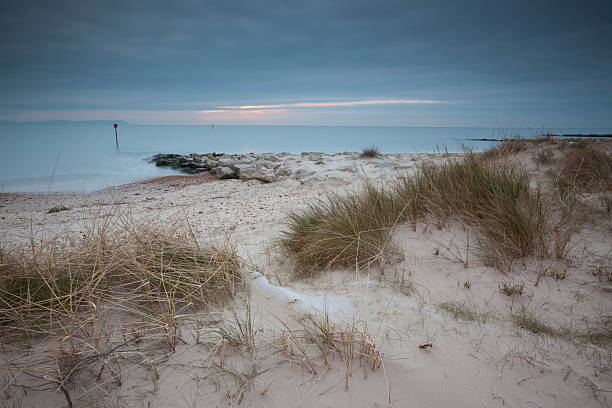 The beach at Hengitsbury Head "Shortly after sunrise across the dunes and beach at Hengitsbury Head, Christchurch, Dorset, U.K" christchurch england photos stock pictures, royalty-free photos & images
