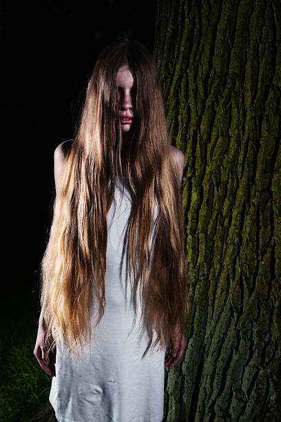 istock Girl Standing at a Tree Trunk 182504951