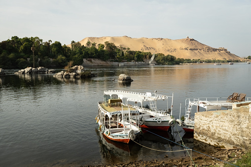 Colorful boat on the Nile river with tourists in Aswan , Egypt