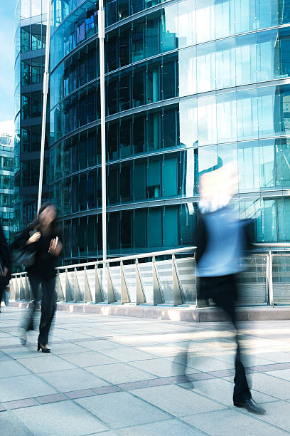 istock Business people walking along office building, blurred motion 182505339