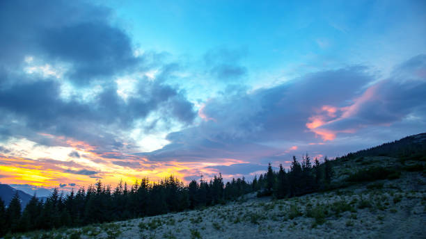 istock brightly colorful clouds in the evening sky. Lush colored clouds in the sky before sunset 1825053839