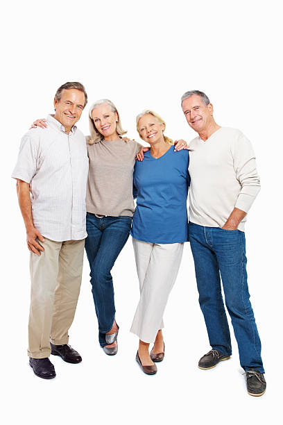 istock Two happy senior couples standing together on white background 182505610