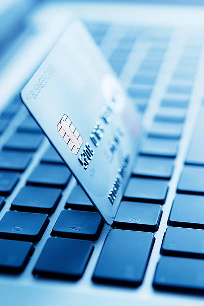 istock Blue tinted image of credit card on laptop 182505757
