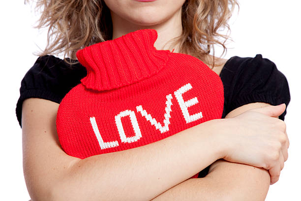 Cozy knitted socks peek out from beneath soft blankets, creating a tender scene of comfort and security. The warmth of home and the gentle textures evoke a feeling of protection and peace, a quiet refuge from the world. Copy space for text, high angle view - Autumn, lifestyle