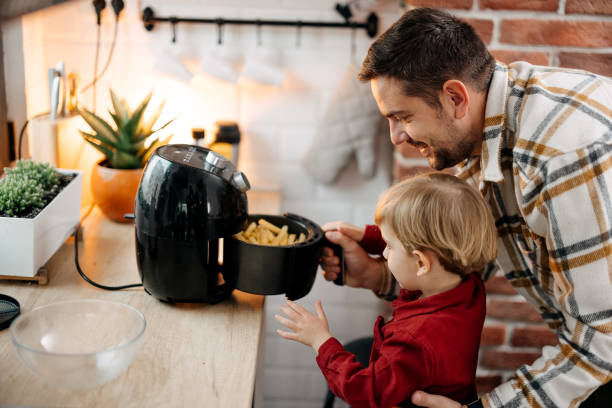 Father and son using air fryer