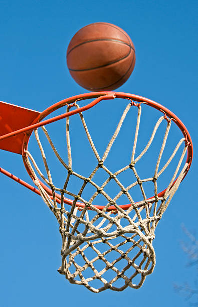 istock Basketball arcing toward hoop 182506453