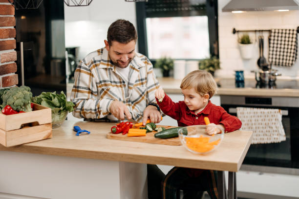 istock Father and son are chopping vegetables 1825065143