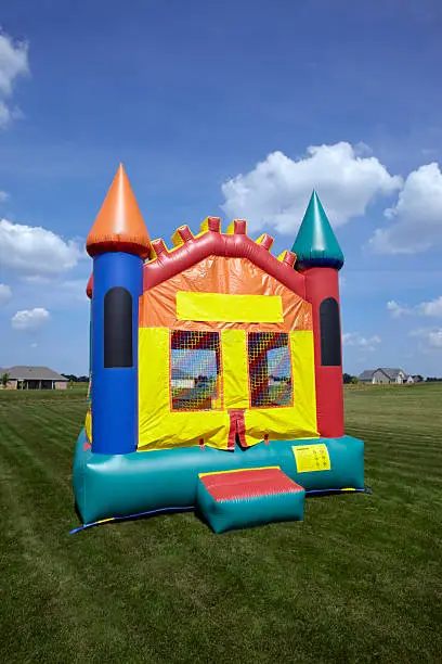 Photo of A large bouncy castle on a freshly mowed lawn