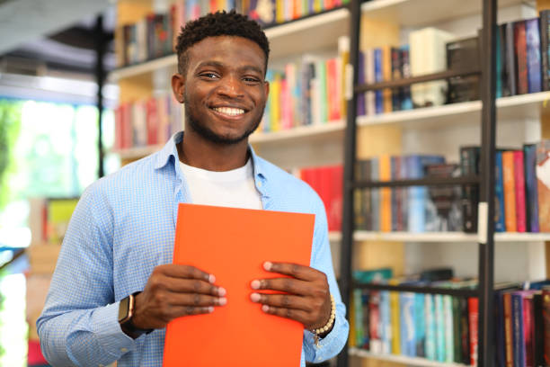 istock A happy and confident student in a library, immersed in education and academic pursuits. 1825067360