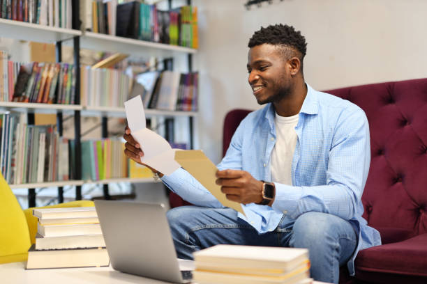 istock Young academic man reading, studying with a laptop, blending education and business. 1825067397