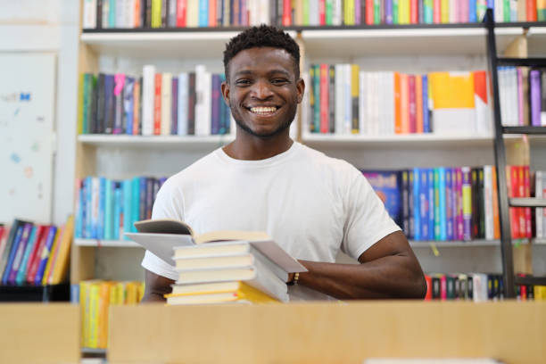istock Cheerful student in a university library, immersed in research, radiating happiness amid books and wisdom. 1825067938