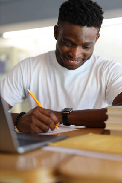 istock Serious young student studying online, typing notes on a laptop, showcasing dedication to education and learning. 1825068506