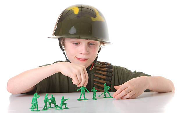 boy with green army men stock photo