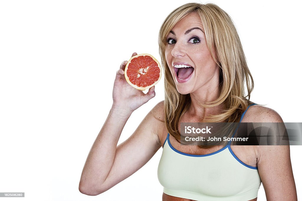 Женщина ест с грейпфрут - Стоковые фото 20-24 года роялти-фри