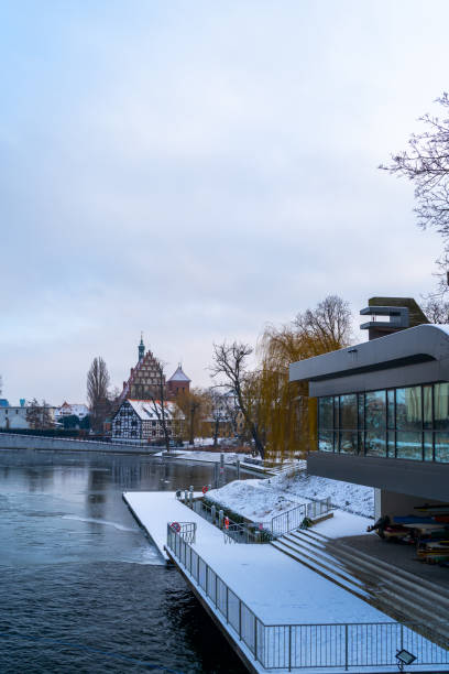 istock Snowy Winter Cityscape with Dock and River 1825083438