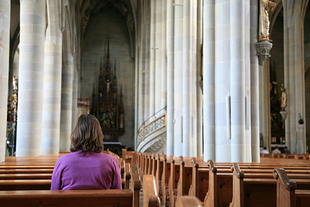 istock Woman inside a church 182508530