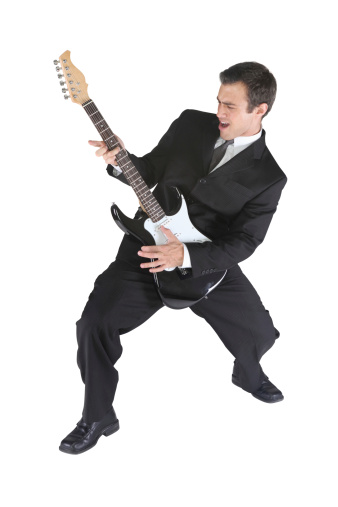 Businessman rocking out with guitar
