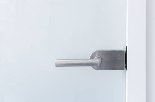 The handle on the sandblasted glass door