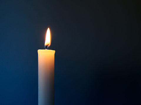 A burning white candle, like one that is lit in churches. For prayers, for hope, or to express condolences.