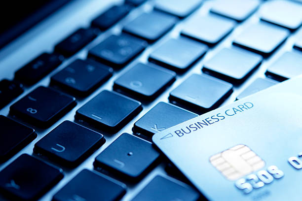 istock Blue tinted image of credit card on laptop 182510281