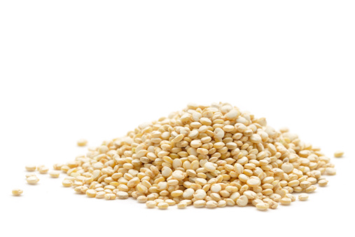 A close up shot of a small pile of Quinoa isolated on a white background.