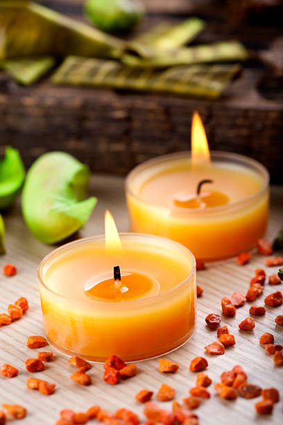 istock Two small orange candles and stones decoration 182511072