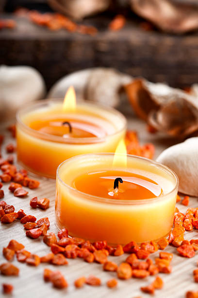 istock Two small orange candles and stones arrangement 182511492