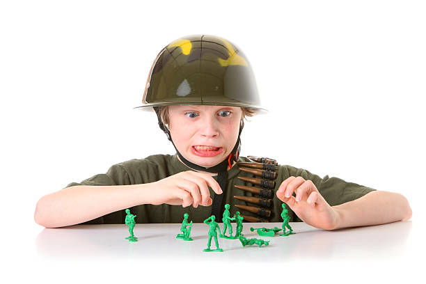 istock boy with green army men 182512457