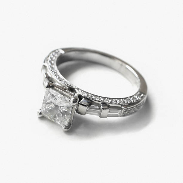 Diamond Engagement Ring on White Background "A princess-cut diamond engagement ring in an antique pave setting with platinum band. Note to buyer: this was shot on film, so there is a slight grain pattern in the white areas." ring tilt stock pictures, royalty-free photos & images