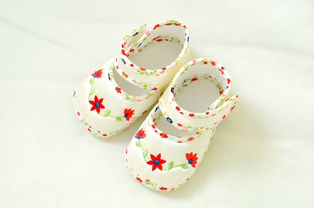 White Baby Shoes on Blanket stock photo