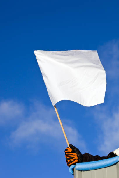 istock White Auto Race Flag against a Blue Sky 182513929