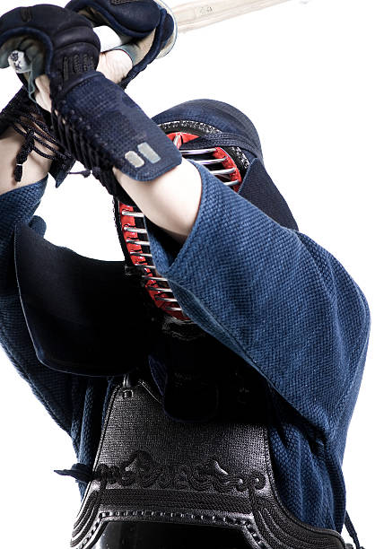 istock Martial Arts - Kendo sensei attacking with bamboo sword (Shinai) 182514254