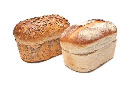 Loaf of brown Seeded Bread and White Bread on a white background