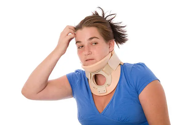A woman wearing a neckbrace worries about future.