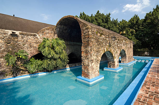 Swimming Pool "The ruins of old warehouses have been transformed into a swimming pool at an old hacienda in Cuernavaca, Mexico." cuernavaca stock pictures, royalty-free photos & images