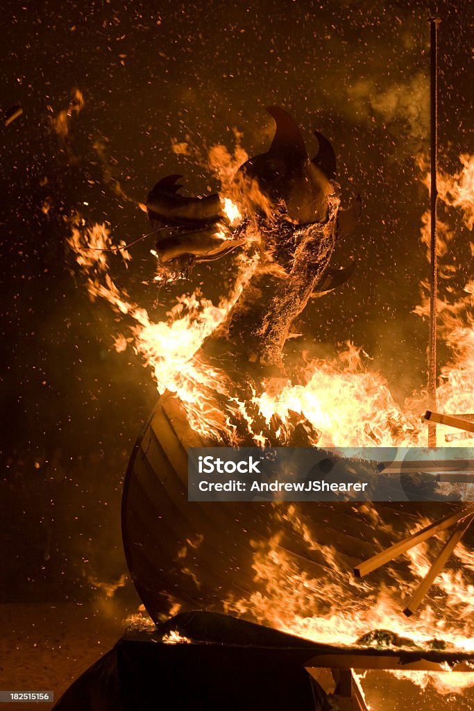 Up Helly Aa Burning Galley Ship "The Up Helly Aa burning galley ship.The stunning 'Up Helly Aa' takes place in Lerwick, Shetland Isles, Scotland on the last Tuesday in January every year. The day involves a series of marches and visitations by the Guizer Jarl (after a 15 year wait) and his squad of fellow vikings, culminating in a torch lit procession of over 800+ vikings and guizers and the burning of the galley. Watched over by thousands of locals and visitors who travel from all over the world to see the spectacular event." Burning Stock Photo